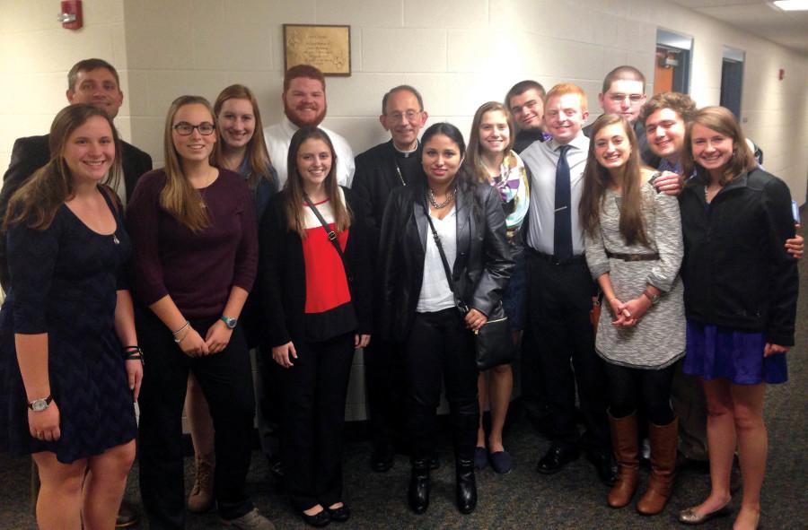 Mercyhurst students and faculty member Greg Baker pose with Bishop Lawrence Persico in Grove City after the annual dinner and discourse event. Students pictured are Rebecca Harms, Michelle Ahrens, Catherine Rainey, Ryan King, Bridget Jacob, Vivian Suazo, Natalie Merucci, Matthew Jury, Tom Matheson, Anna Warner, Michael Best, Sergio Cortes and Mary Jaskowak.