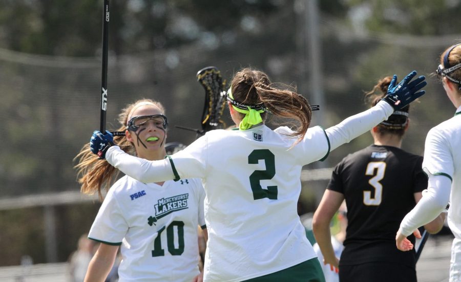 Junior No. 2 Taylor Izzo and Senior No. 10 Carly Zimmerman celebrate during Saturday’s game against Bloomsburg University.  Zimmerman led with six goals and Izzo three in the 13-5 win.