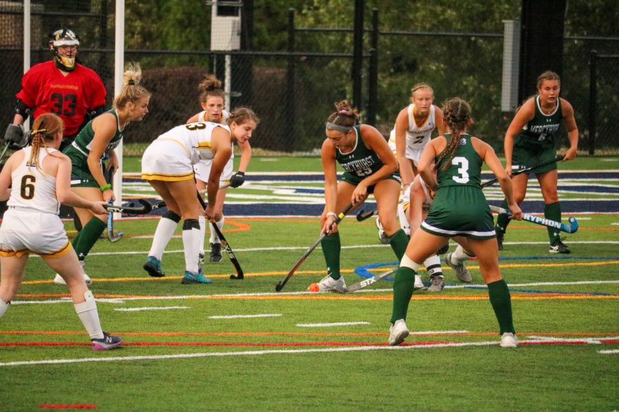 Clare Ahern, right, swipes the ball away from players from Millersville University. Teammate Mia D’Amato (No. 3) watches in the foreground.