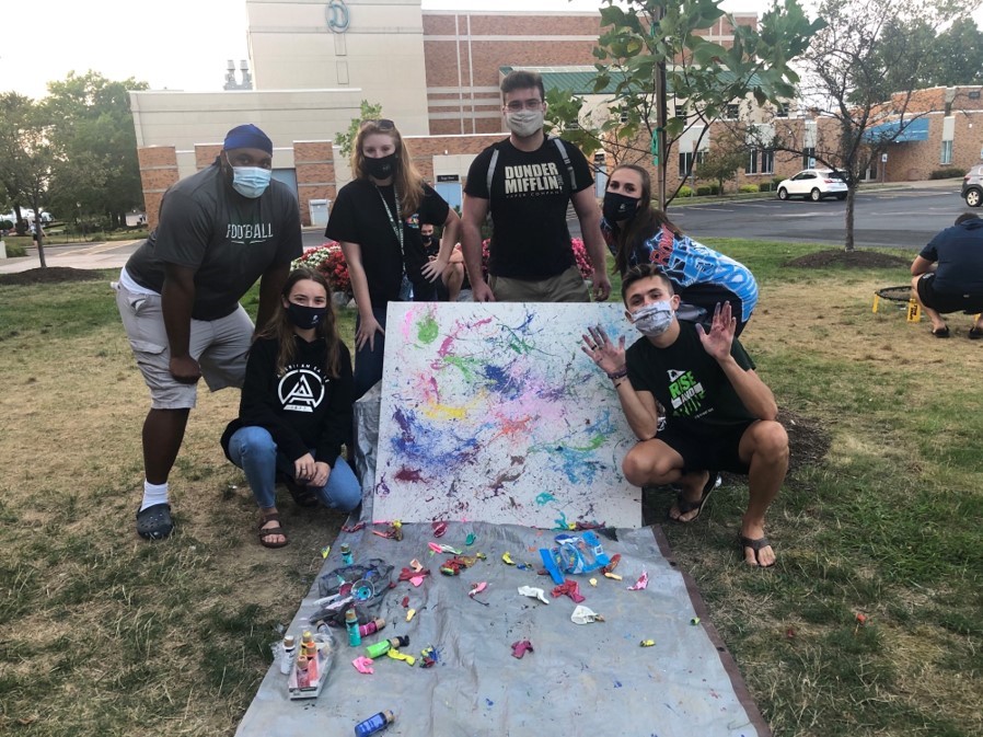 Warde Hall RAs and residents mask up to enjoy an event called “Pop the Bias” with splatter paint. 