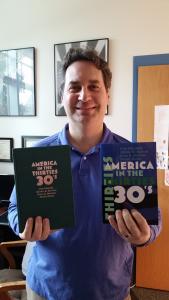 Karah Hollis photo: Co-author Brian Sheridan poses with his recently published textbook, “America in the 30s.” Other co-authors include Marnie Sullivan, Ph.D., Mercyhurst History professor John Olszowka, Ph.D., and Edinboro History professor Dennis Hickey, Ph.D.