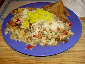 Breakfast Place&amp;#039;s Frittata omelette: The omelette consists of a scramble of three eggs, sausage, pepper, onion, potato, and mushroom topped with mozzarella cheese and banana peppers. This large sized portion is only $6.99.
