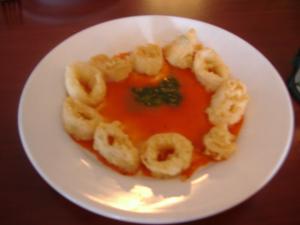 Arnone's Calamari Fritti are breaded calamari rings served with roasted red pepper coulis and basil pesto.