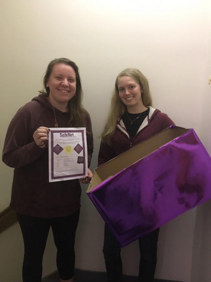 Kelly Peters and Emily Jarrett hold the boxes they placed around campus.