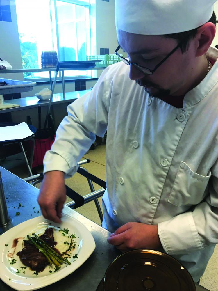 Aaron Ellis, senior Hospitality Management major, opened the fall dining series with “A Blackberry Dream,” making balsamic honey and mustard pork chops.