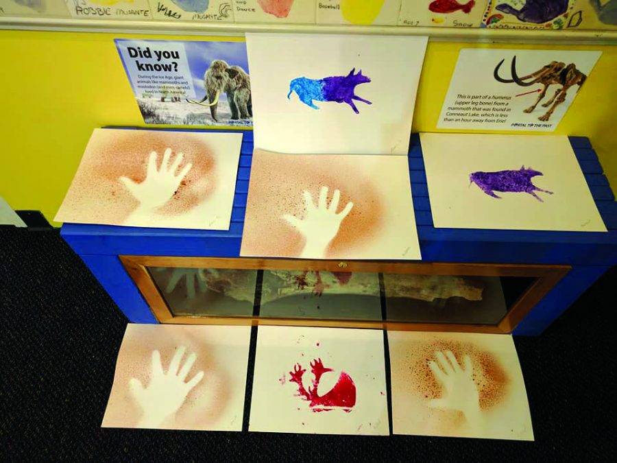 Children at Experience Children’s Museum got to make hand artwork that resembled cave drawings.