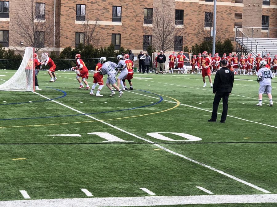 The Lakers’ Nathan Grenon, at center, battles in front of the Seton Hill University goal.  Seton Hill would go on to win the matchup 11-9.