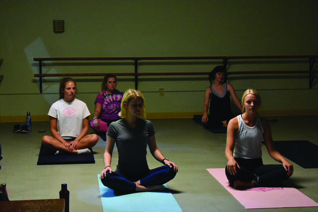 Students participate in a yoga class run by Dance major Niusha Karkehabadi.