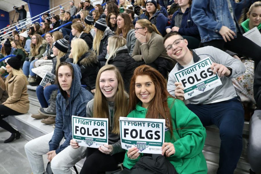 Students show their “I Fight For Folgs” signs at the men’s hockey game on Saturday Jan. 26