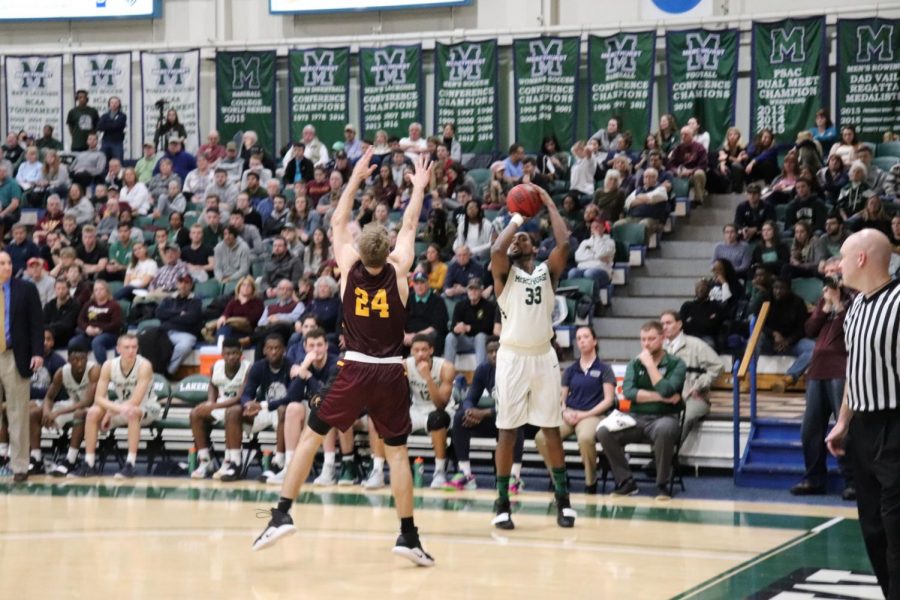 The Lakers’ No. 33 Patrick Smith aims to shoot as Gannon University’s Joe Fustine moves to block.  The Lakers were victorious with a 51-35 finish, taking home the 2019 Porreco Pride of Erie Cup.