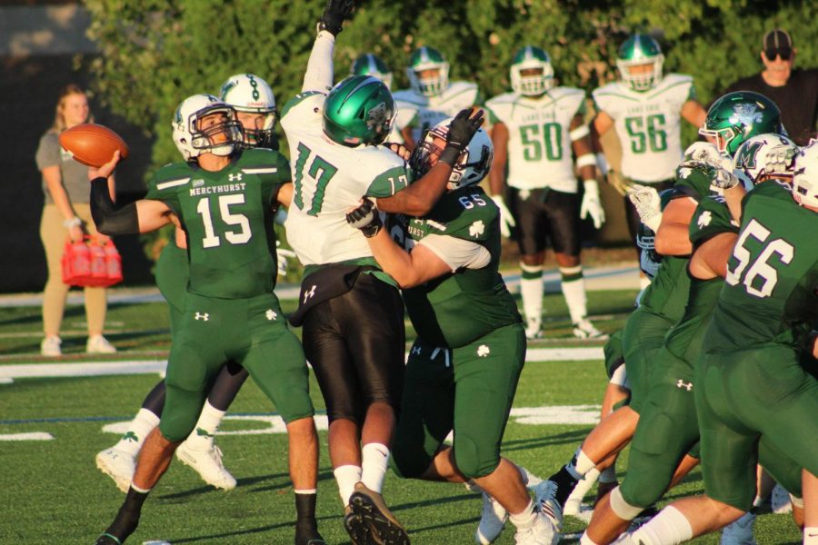 Laker quarterback No. 15 Doug Altavilla looks to throw as No. 65 offensive linebacker Aaron Smith grapples Lake Erie’s No. 17 TJ Flowers. Staving off a comeback, the Lakers won 21-16 over Lake Erie.